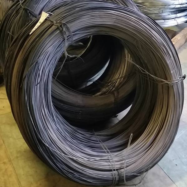 There are several coils of black annealed wires on the ground.