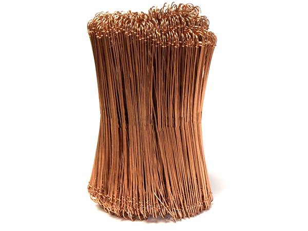 A roll of copper double loop bale ties on white background.