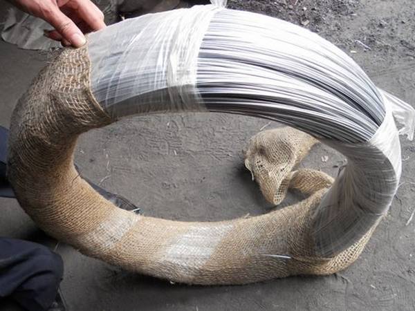 A roll of galvanized binding wire with plastic film and hessian cloth package.