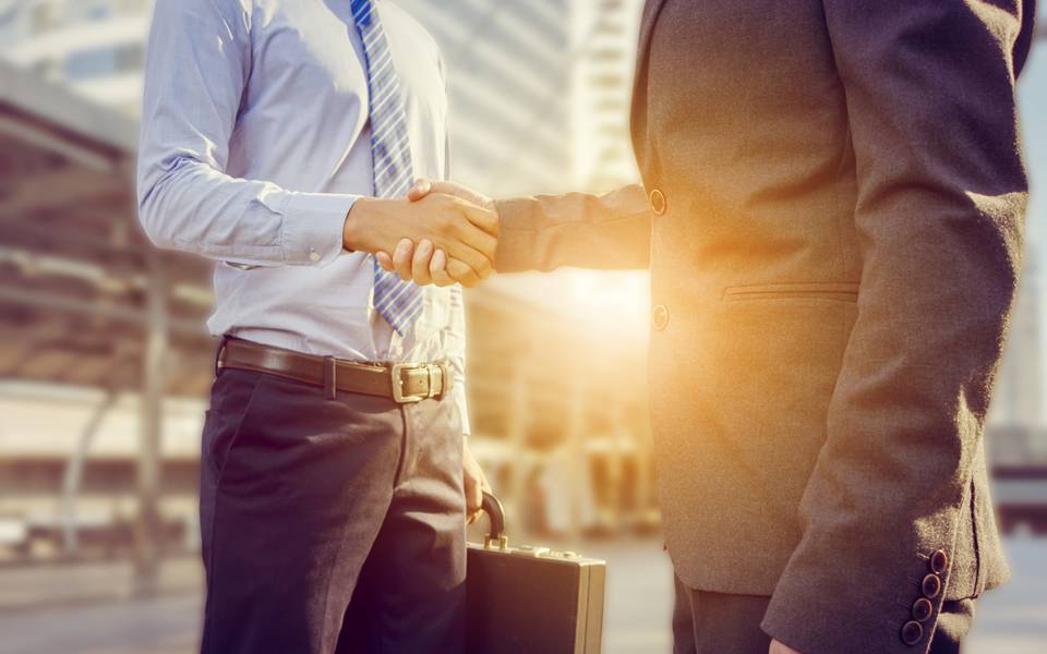 Two men are handshaking.