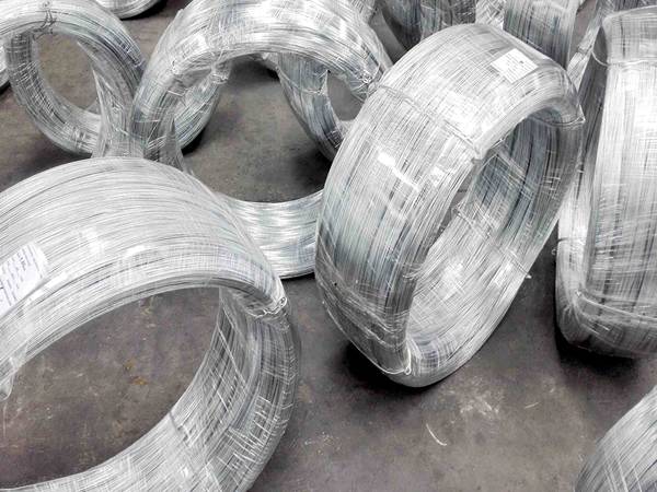 Several rolls of galvanized steel wires are packed with plastic films.