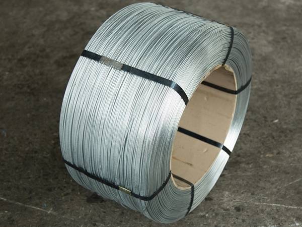 A roll of oval shaped wire on the ground.